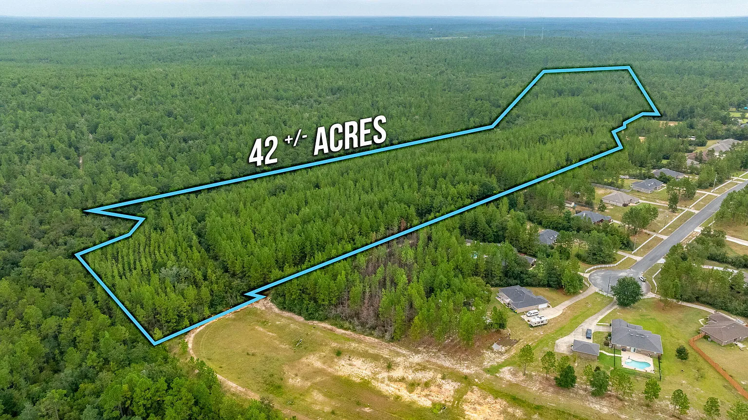 Aerial view of 42-acre Welannee Blvd estate with boundary outline